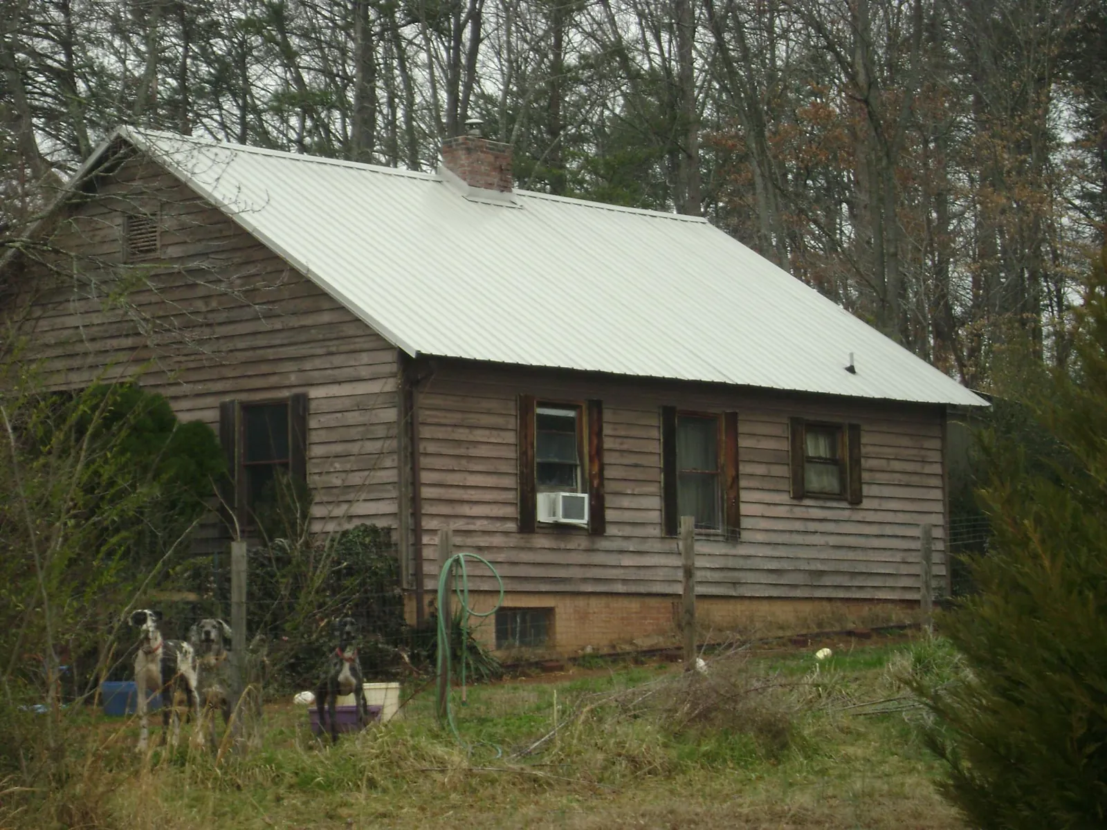 White metal roof on an old wood sided farmhouse, from a Metal Roof Installation job in Gilroy